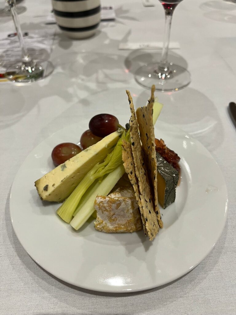 plate of cheese with fancy crackers and grapes