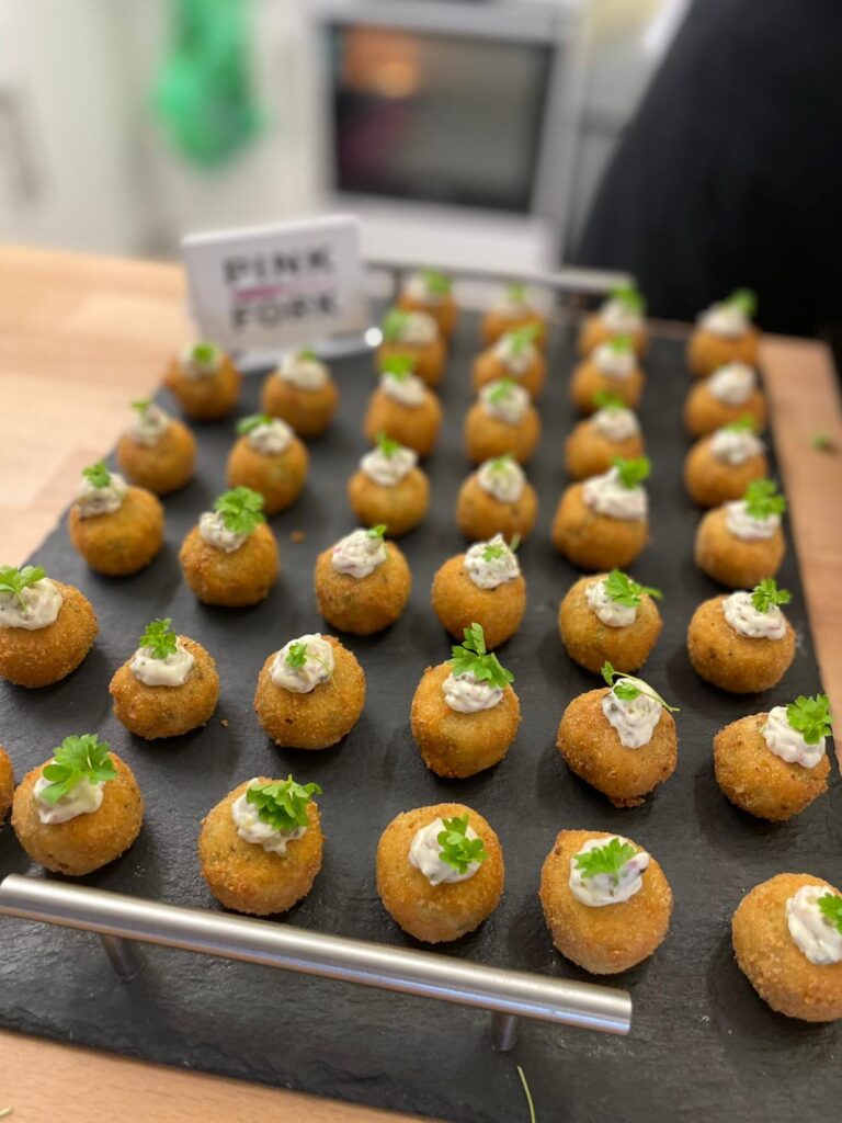 tray of canapes with pink fork sign