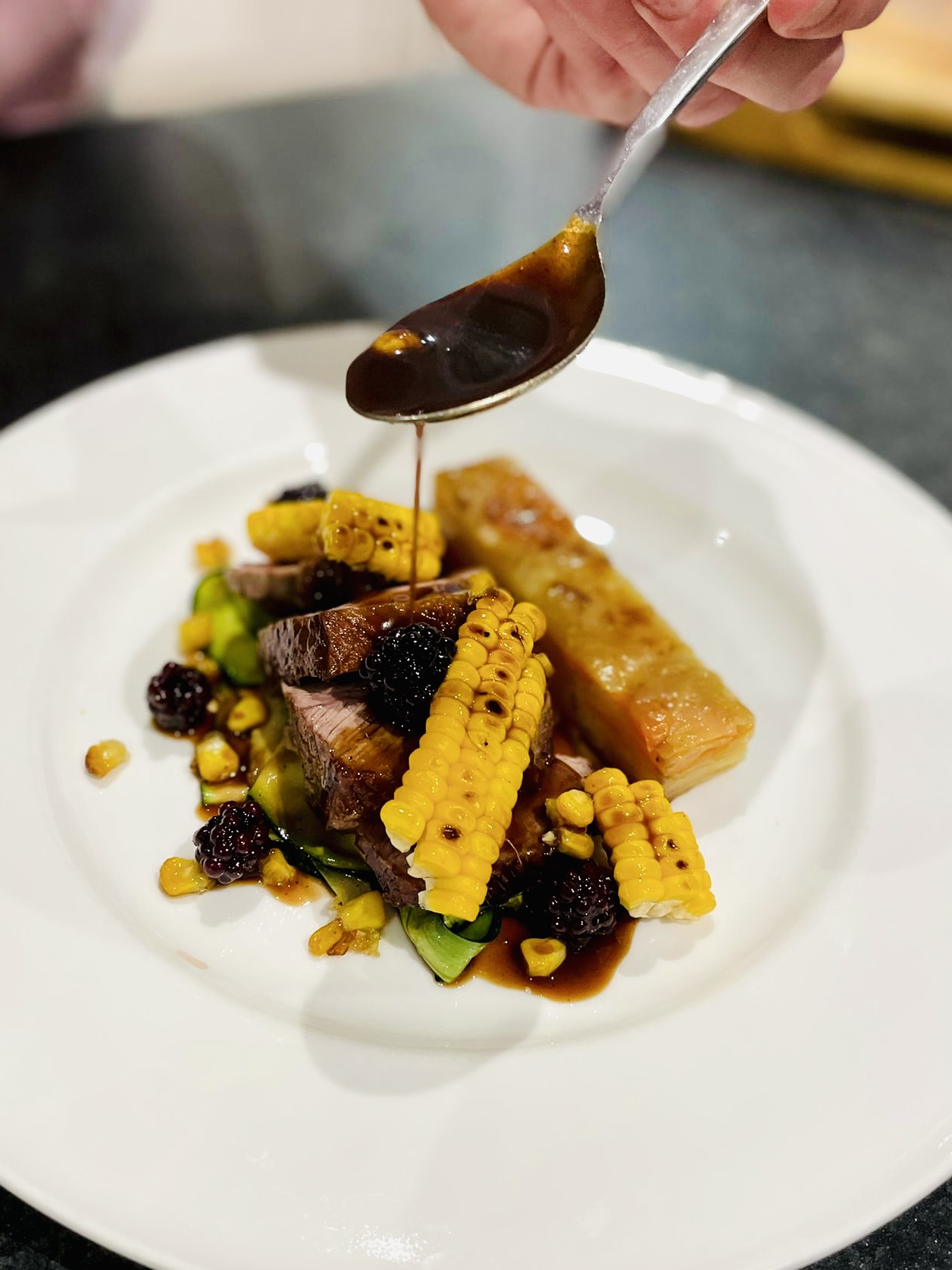 meat dish with blackberries and sweetcorn