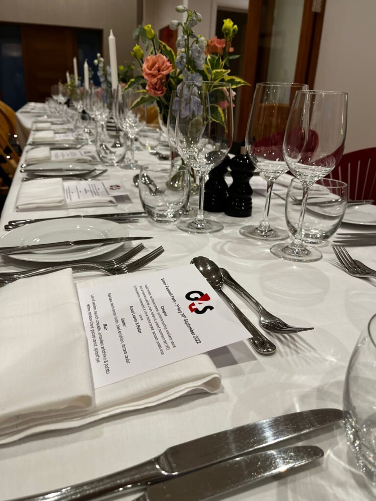 banquet table laid with cutlery and glasses